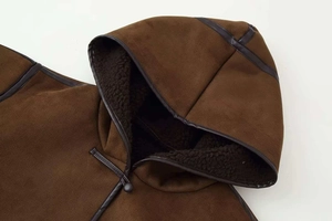 Detail of faux suede jacket with dark brown faux shearling lining and toggle closure
