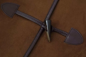 Detailed close-up of dark toggle buttons and leather patches on brown suede jacket coat