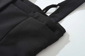 Close-up of the black knitted fabric texture and waist strap stitching detail
