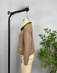 Detailed texture of brown knit jacket with vibrant neon yellow trim and soft wool fabric