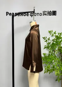Detailed close-up showing the silky satin texture and buttoned cuff of this coffee brown shirt