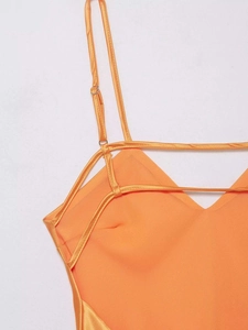 Détails des fines bretelles réglables et du col en V sur cette robe midi en satin orange