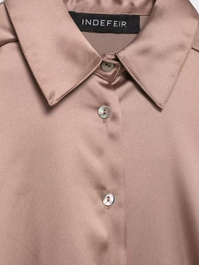 Detail of satin shirt collar with pearl buttons and smooth silky fabric texture