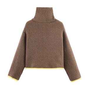 Detail of dark brown knit sweater with high collar and bright yellow contrast piping edges