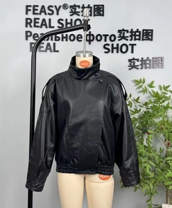 Detailed view of black lychee grain faux leather jacket with stand collar and epaulettes