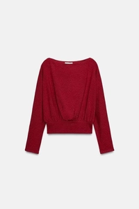 Detailed view of dark red off-shoulder knit top featuring elegant waist pleated texture