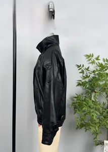 Detailed view of black litchi texture leather jacket with ribbed cuffs and stand collar