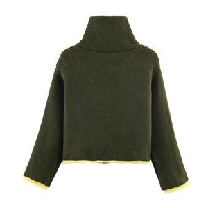 Detail of dark green knit sweater featuring contrast yellow trim and high neck collar