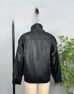Detail of black vintage faux leather jacket showing V-shaped back stitching and lychee texture