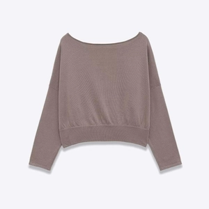 Detail of off-shoulder boat neck knitted sweater with ribbed hem in dusty purple