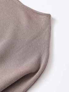 Macro shot of taupe knitted fabric showing the fine ribbed texture and quality stitching