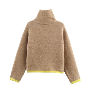 Detailed view of camel faux shearling jacket with neon yellow contrast trim on sleeves