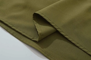 Detail shot of army green fabric with high-quality single needle stitching on the edge