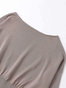 Close-up of elegant off-the-shoulder knit top with fine texture and clean stitching