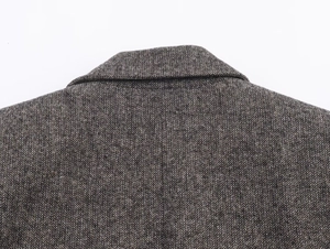 Detail shot of vintage herringbone weave pattern on tailored wool blazer collar