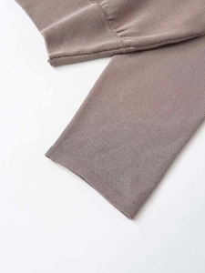 Detail of ribbed cuffs and stitching on this mauve off-the-shoulder knit top