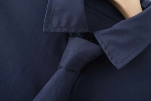 Detail of navy blue cotton poplin shirt with matching tie and classic square collar