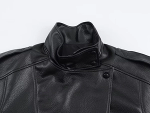 Close-up of black lychee grain leather jacket collar with snap buttons and stitching