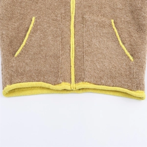 Detail of brown fleece jacket with contrast yellow zipper and hemmed pockets
