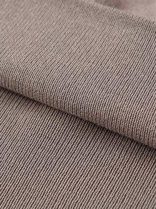 Macro detail of high-quality ribbed knit fabric in neutral taupe with elastic texture