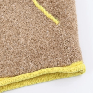 Close-up of contrast stitching and yellow trim on camel fleece jacket fabric details