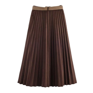 Detail of pleated brown midi skirt with fine vertical folds and thin waist belt