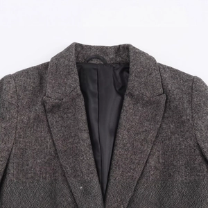 Women's herringbone tweed blazer jacket with notch lapels and textured wool fabric