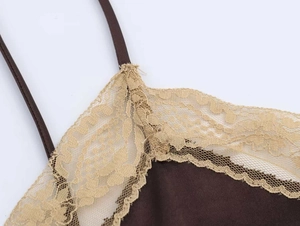 Detail of dark brown satin camisole featuring delicate champagne lace trim at the neckline
