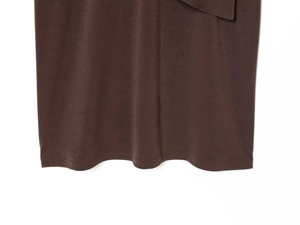Detailed close-up of dark brown fabric hem with neat double-needle stitching and texture