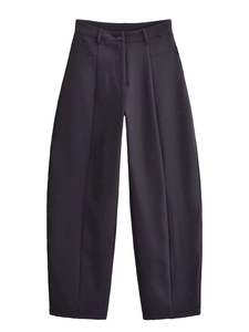 Detailed view of high-waist pleated formal trousers with vertical creases and slim-fit cut