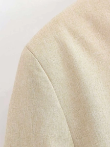 Macro shot of high-quality linen texture fabric on beige vintage short blazer jacket