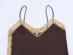 Detailed view of dark brown satin camisole featuring delicate gold eyelash lace trim