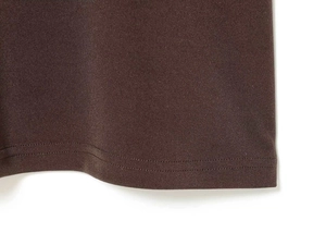 Close-up of the double-needle stitched hem on a brown off-the-shoulder maxi dress