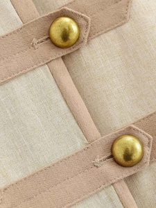 Detail of vintage cream woven blazer with contrast piping and golden metal buttons