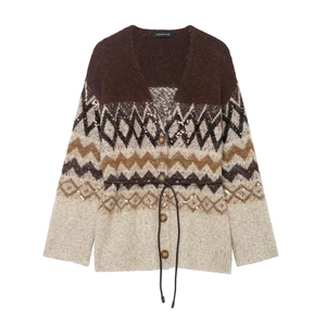 Close-up of geometric knit cardigan featuring sequin accents and round wooden buttons