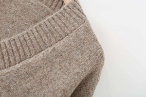Detailed macro view of beige ribbed knit texture and premium soft wool blend fabric