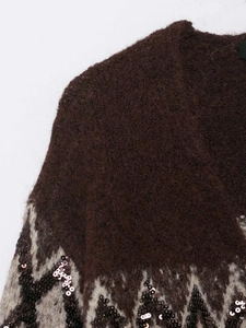 Detail of mohair cardigan showing sequined geometric jacquard pattern and soft texture