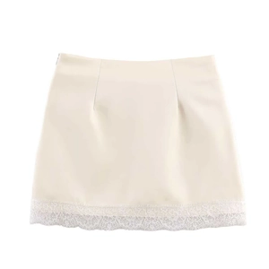 Elegant cream high-waisted mini skirt with delicate white lace trim on the hemline