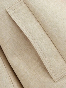 Detailed macro shot of khaki cotton-linen blazer fabric and precision double stitching