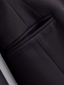 Detail of side pocket on black slim fit blazer showing high quality woven fabric texture