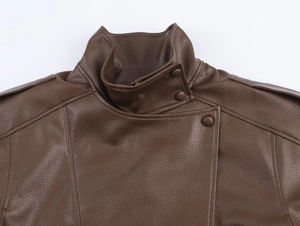 Close-up of brown leather jacket collar with epaulettes and asymmetric button closure