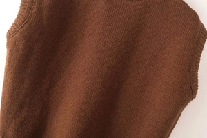 Close-up of brown knit texture and ribbed edge detail on sleeveless vest top