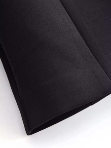 Close-up of premium black suit fabric showing professional stitching and high-quality texture