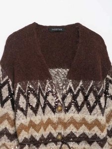 Detail of dark brown knit cardigan with sequin accents and slim leather waist belt