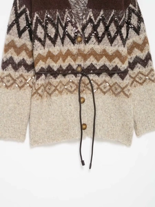 Detail of vintage geometric knit cardigan with sequins and a brown leather belt