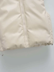 Detailed view of beige faux leather vest showing center zipper and adjustable drawstring hem