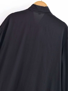 Detailed back view of black V-neck long sleeve blouse featuring bow detail on wooden hanger