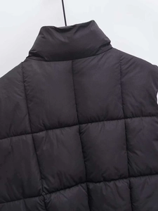 Detail of the high collar and square quilted pattern on the back of this black puffer vest
