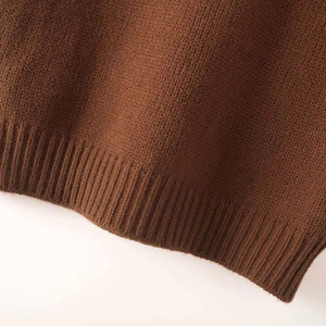 Coffee brown sleeveless knit vest with high collar and ribbed hem on a clean white background