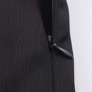 Close-up of a concealed black invisible zipper on a mini skirt with smooth fabric detail